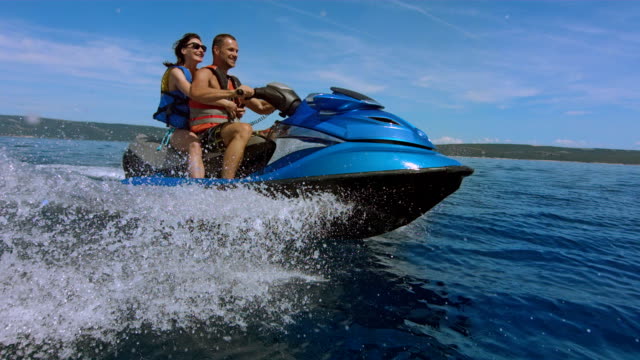 SLO MO Joyful Couple Riding A Jet Boat