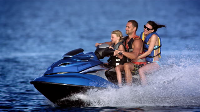 SLO MO Family Riding A Jet Boat