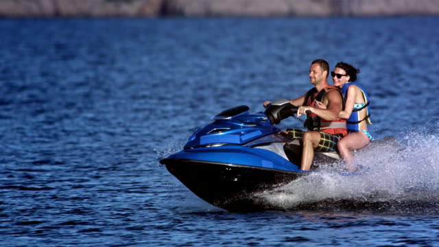 SLO MO Couple Riding A Jet Boat