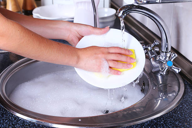 istock Female hand with sponge washing dish 466160912