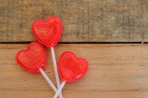 istock Red romantic heart shaped lollipops on wooden pallet 466163686