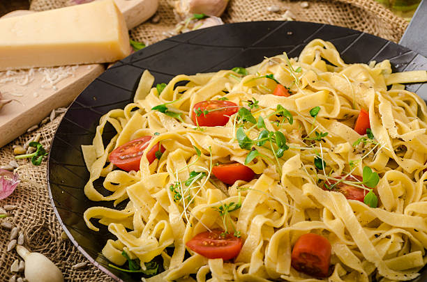 istock Semolina pasta with roasted garlic, sprinkled microherbs 466164372