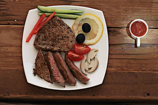grilled meat on a plate serving rustic wooden background