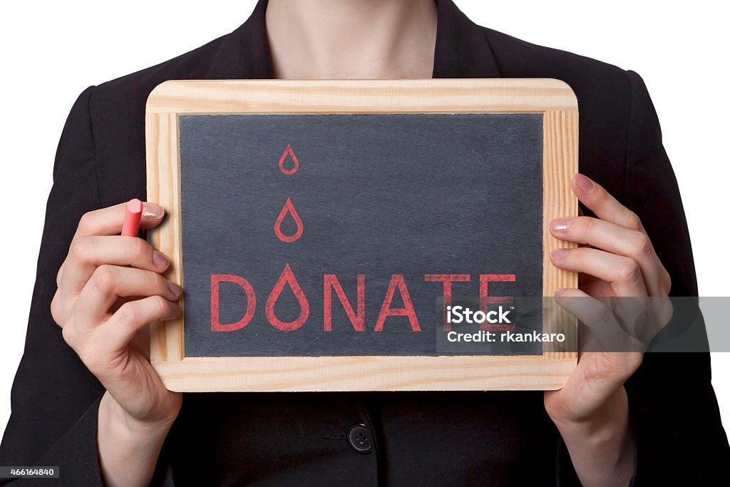 blood donor donate blood black board. Healthcare chalk board with blood drops and donate text. Save life by donating blood. woman holding information sign. 2015 Stock Photo