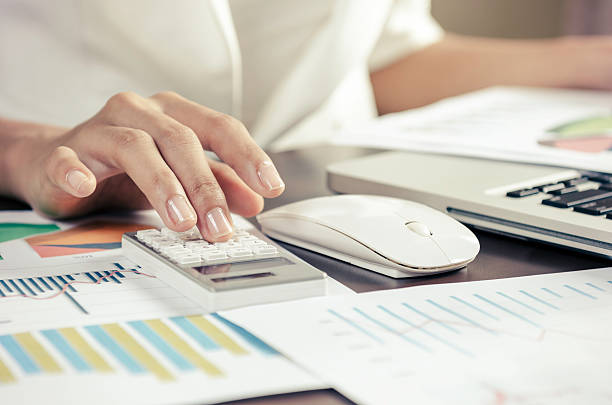 istock Person working with calculator on desk 466169152