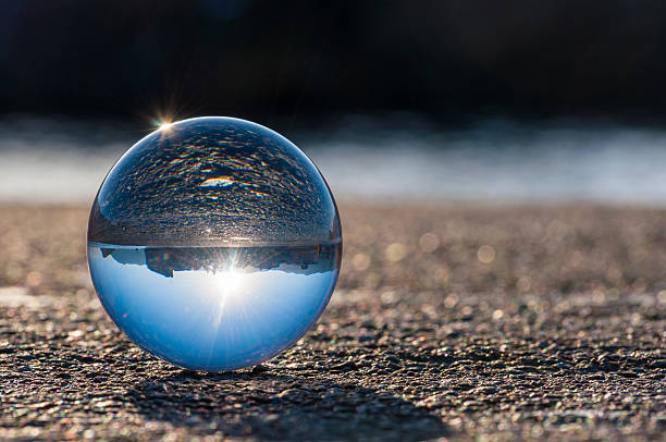 istock Glass transparent ball on dark background and grainy surface 466169330