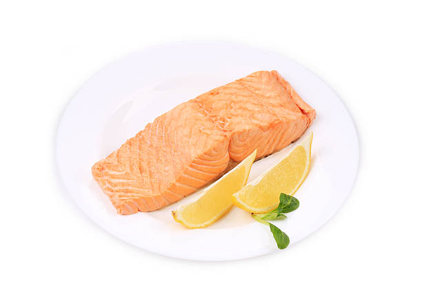 istock Fried salmon fillet on plate with lemon. 466171843