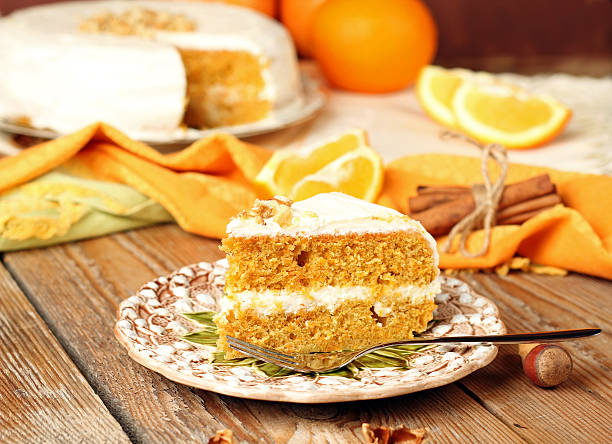 istock Carrot cake on wooden table with oranges, nuts and cinnamon 466172080