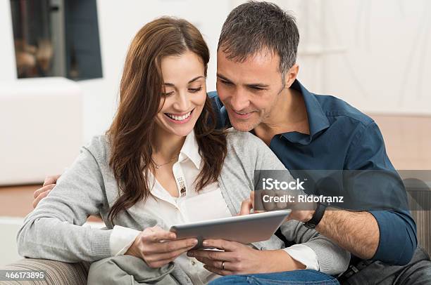 Couple Using Digital Tablet Stock Photo - Download Image Now - Couple - Relationship, Computer, Desktop PC