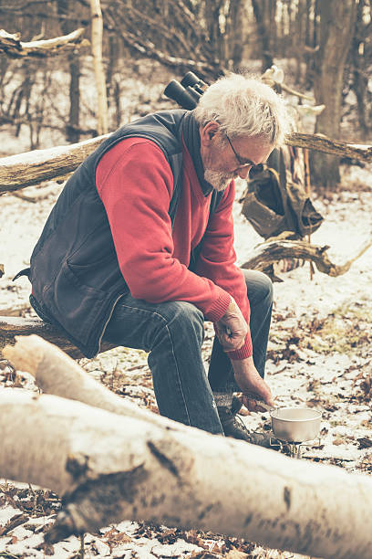 istock Old Man at the Forest Cooking for Food 466174842