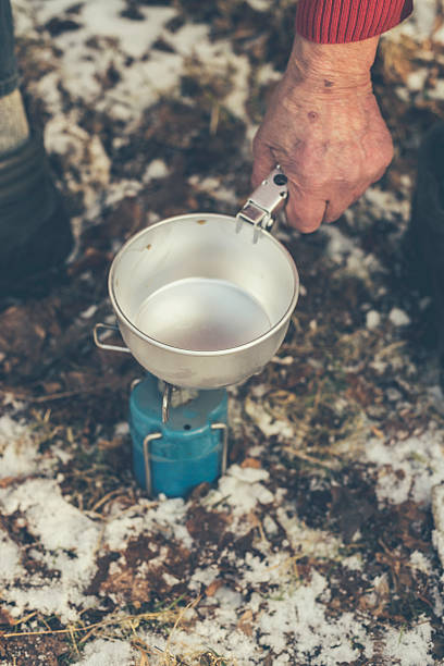 istock Camper at the Forest Cooking with Portable Stove 466174844