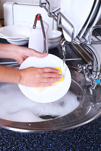 istock Female hand with sponge washing dish 466175238