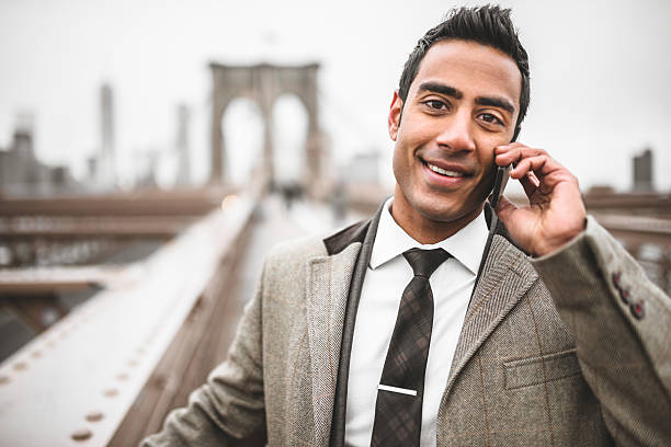 istock Businessman on the phone in brooklyn bridge 466176397