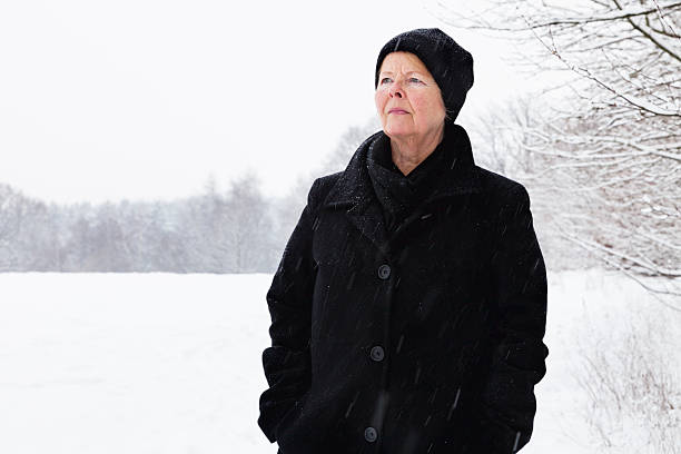 istock pensive senior woman in winter 466176765