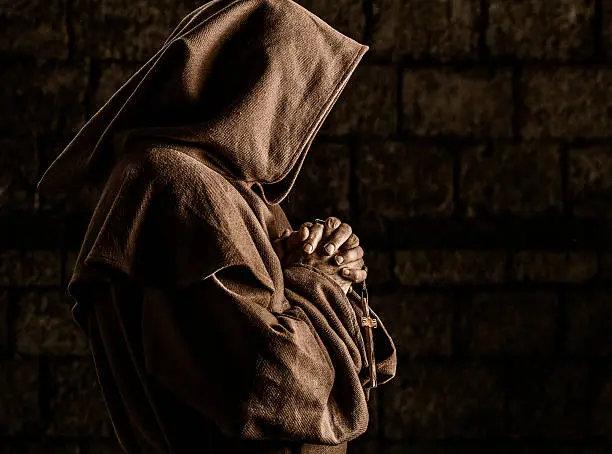 Monk praying in abbey