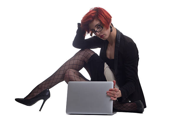 Stylish modern red haired business woman with powerful laptop stock photo