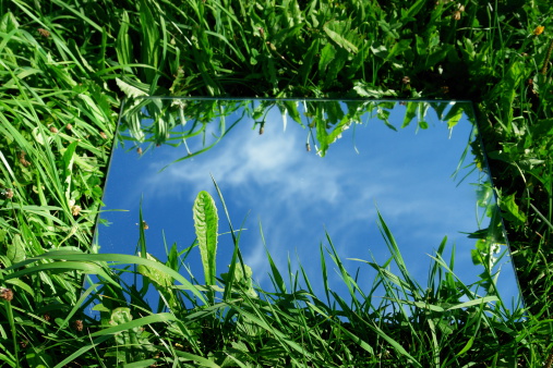 Close-up of a mirror showing the sky