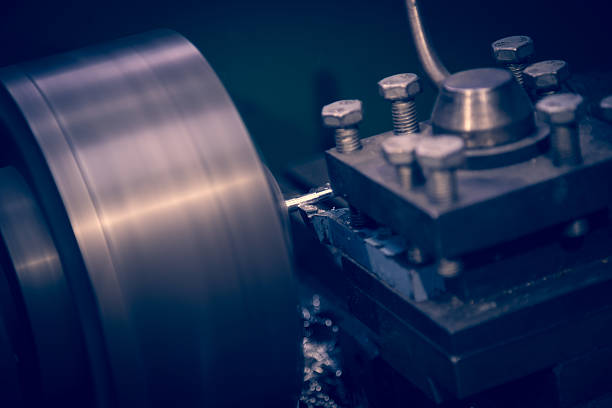 istock Lathe machine operates on steel rod. 466181600