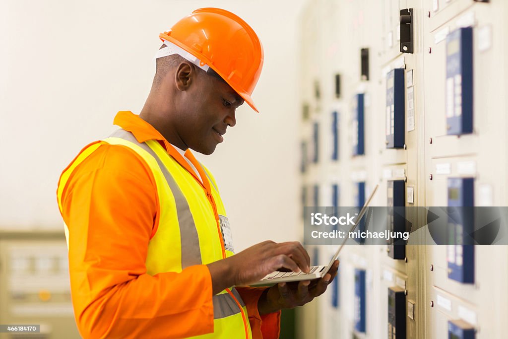 young african control room engineer using laptop handsome young african control room engineer using laptop 2015 Stock Photo