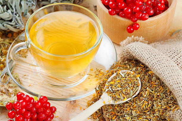 istock cup of herbal tea, medicinal herbs and healthy berries 466187045