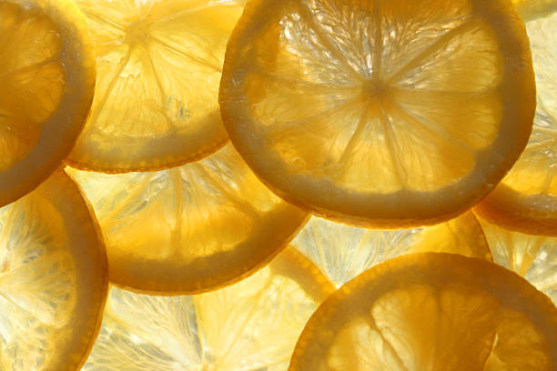 istock Image of lemon slices / overlapping sliced citrus fruit background, backlit 466187826
