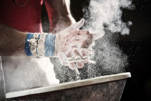 Human gymnastic hands covered with chalk powder.   