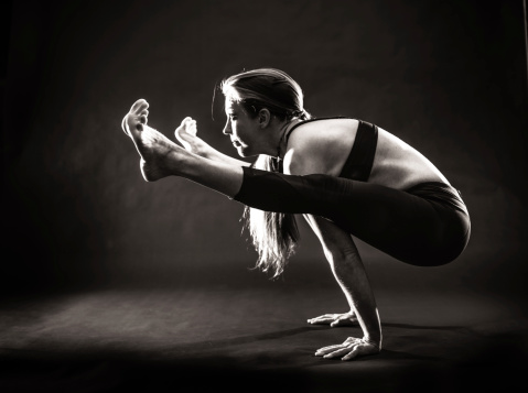 A women doing extreme yoga poses on a black background. http://blog.michaelsvoboda.com/YogaBanner.jpg
