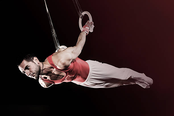 istock Young sportsman on gymnastics rings. 466188113