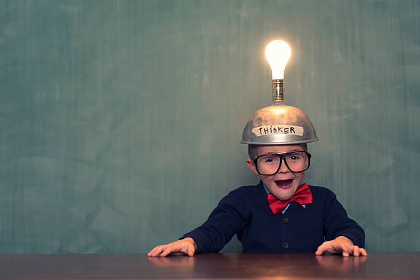 Big Ideas A young boy and nerd has just hit the jackpot of large ideas. big idea stock pictures, royalty-free photos & images