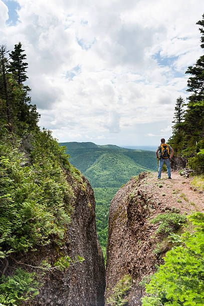 istock Man hiking near deep crevasse 466192961