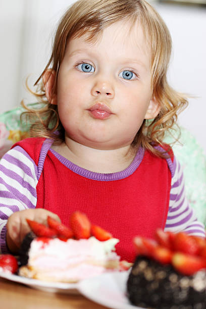 istock girl eating cake 466195733