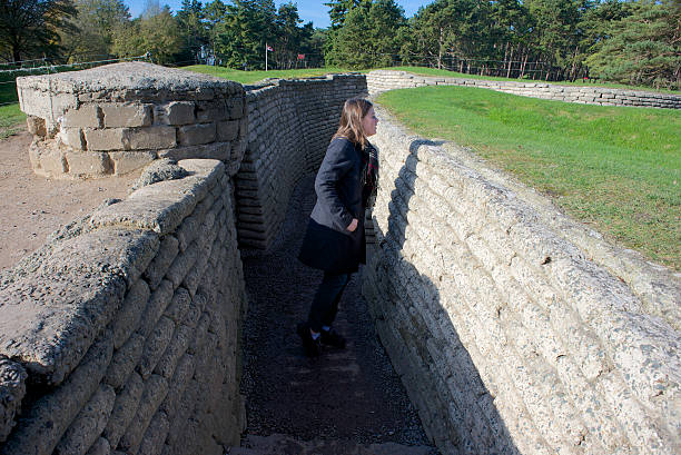 World War One trenches, Vimy Ridge, France Vimy Ridge, France - November 11, 2014: A visitor to the Canadian War Memorial looking out over the battlefield from the Canadian trenches, preserved since World War One.  vimy memorial stock pictures, royalty-free photos & images