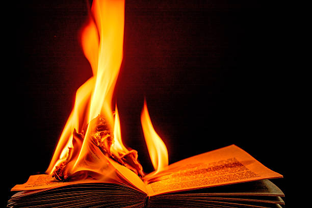 istock Burning book engulfed in brilliant  flames-  black background. 466196774