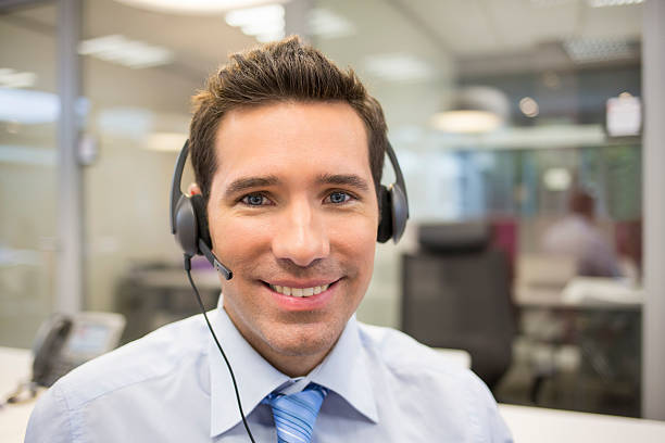 Businessman at office on the phone with headset stock photo