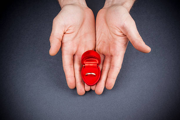 istock Close up of man holding engagement ring 466197886