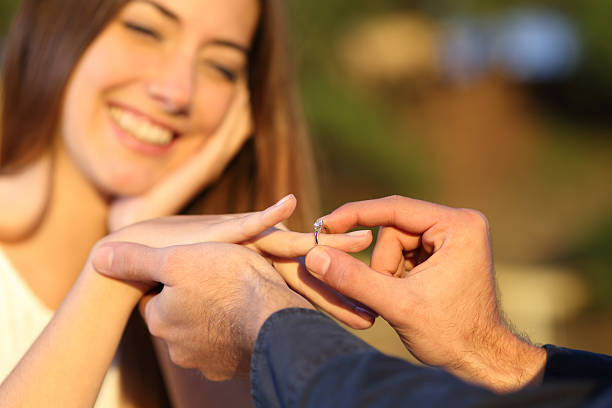 istock Boyfriend putting a engagement ring in his girlfriend finger 466200782