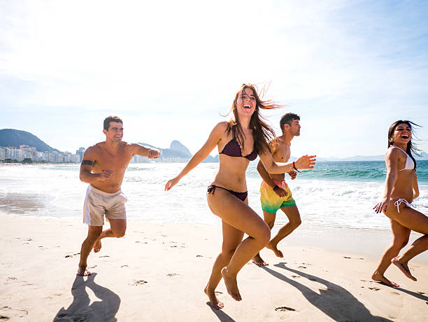 istock Cheerful people chasing on the beach and having fun. 466201688