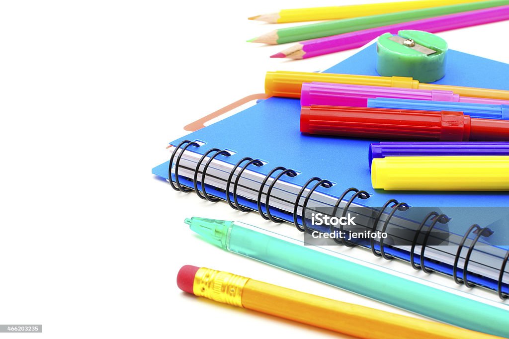 Notebook close up with colorful pens and pencils over white Back to School Stock Photo