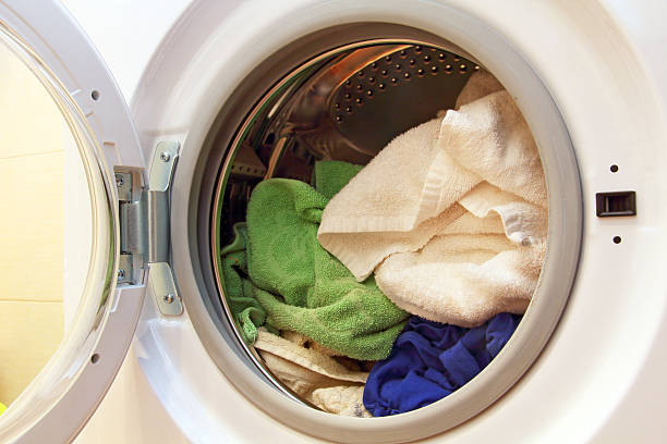 istock Clothes inside of washing machine. 466203264