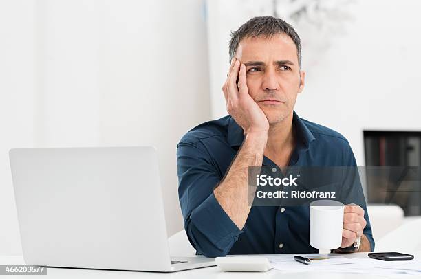 Unhappy Man At The Desk Stock Photo - Download Image Now - Men, Contemplation, Businessman