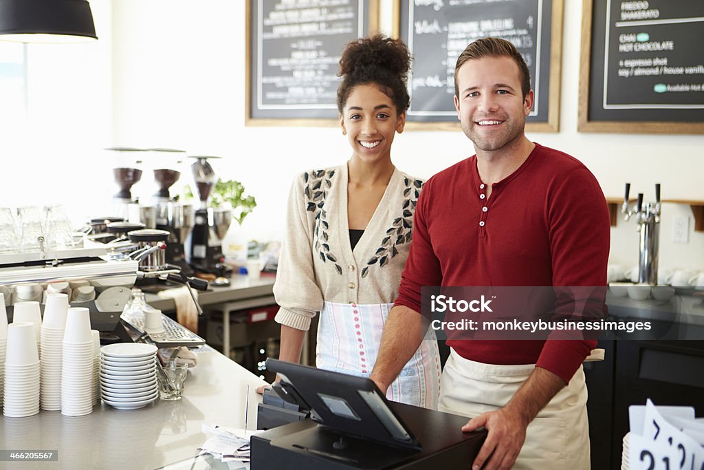 Coffee shop workers smile for photo Male Owner Of Coffee Shop With Employee Restaurant Stock Photo