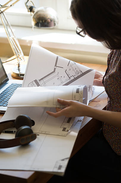 istock Woman working at home with laptop and architecture plan 466206604