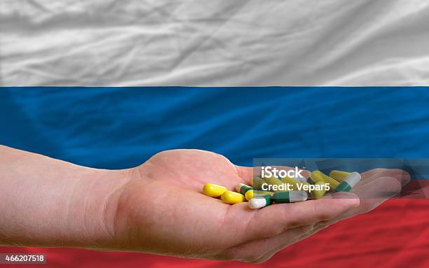 Holding Pills In Hand And Flag Of Russia Stock Photo - Download Image Now - 2015, Addiction, Adult