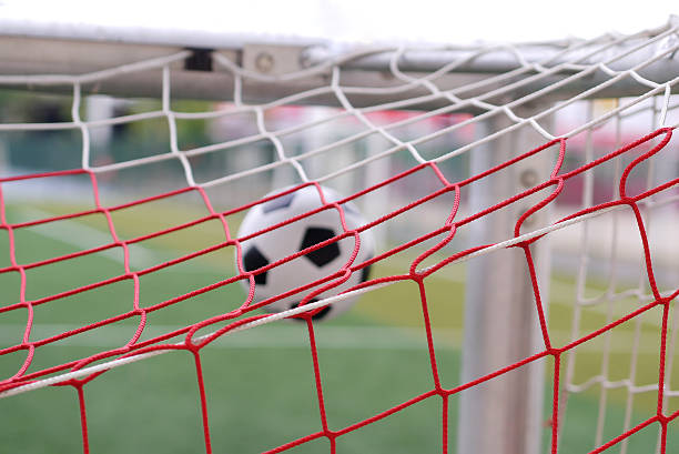 istock soccer football in goal net 466207918