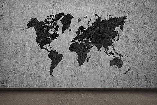 drawing world map on gray concrete wall