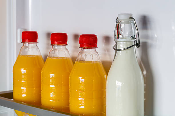istock Open fridge filled with orange juice and milk 466208432