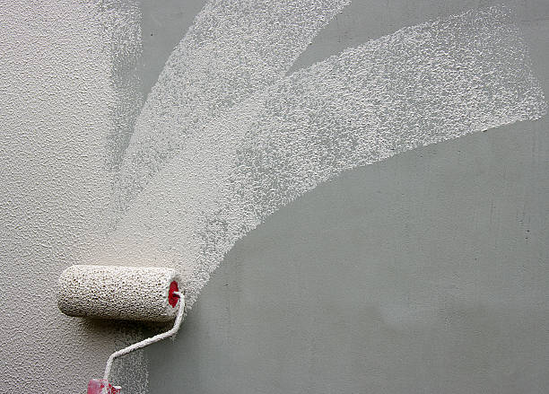 istock A picture of a gray wall being painted white 466208436