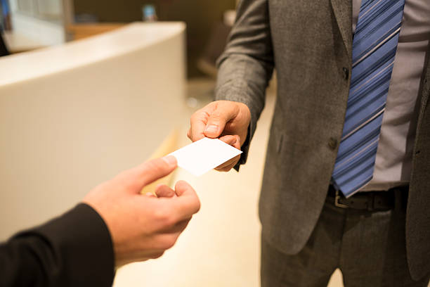 istock Closeup of two successful business executive exchanging cards 466210163
