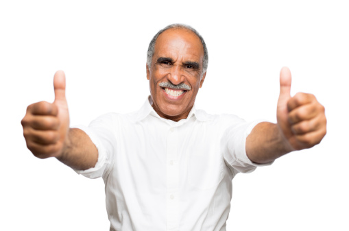 A mature latin man giving a thumbs up to the camera.