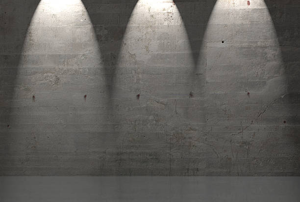 istock A gray concrete wall with three spotlights shining down. 466211353